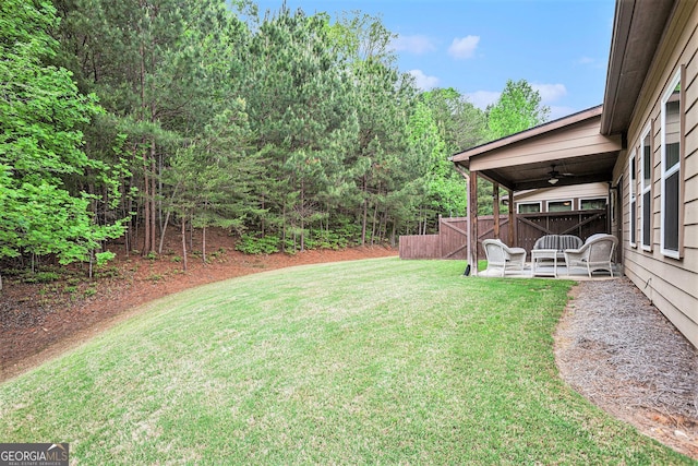 view of yard with ceiling fan, a patio area, and fence