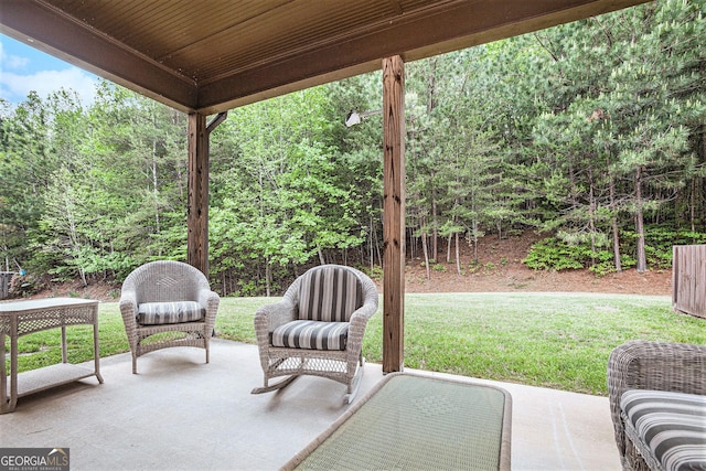view of patio / terrace featuring a wooded view