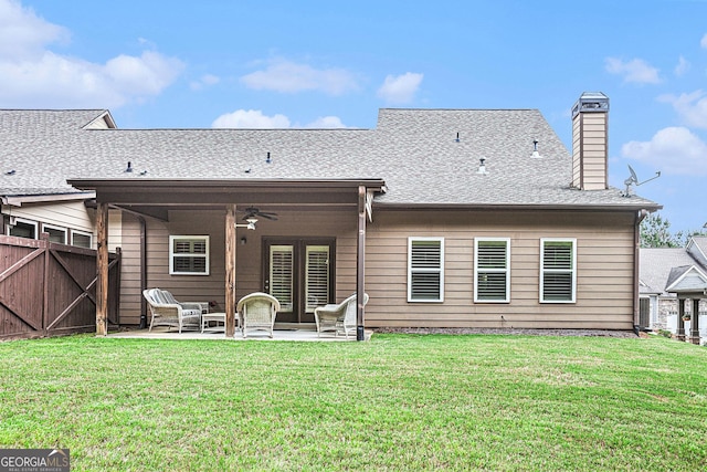 rear view of house with a lawn, ceiling fan, and a patio area