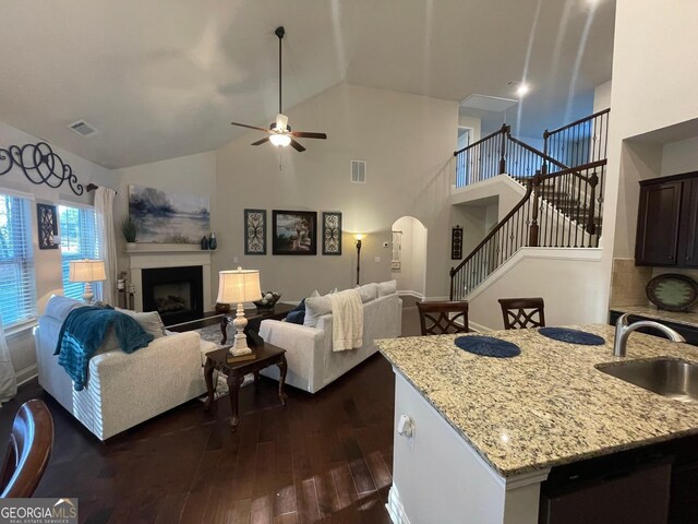 3708 Southfield Ct Unit 43A, Loganville, GA 30052 - living area with arched walkways, stairs, dark wood-type flooring, a fireplace, and a ceiling fan
