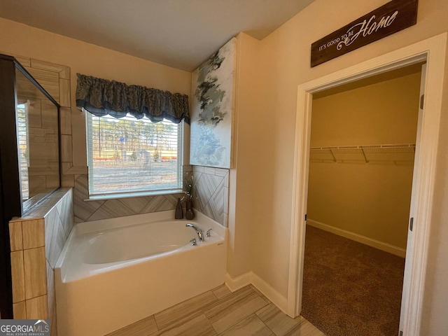 3708 Southfield Ct Unit 43A, Loganville, GA 30052 - bathroom with a bath, a spacious closet, and a shower