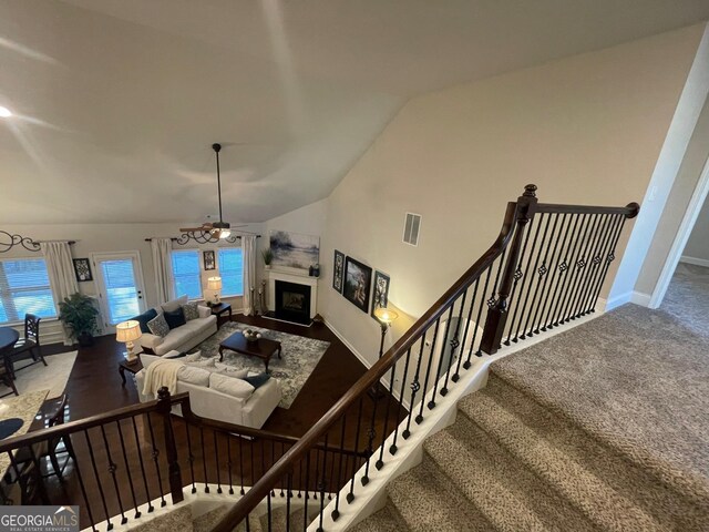3708 Southfield Ct Unit 43A, Loganville, GA 30052 - living area with a fireplace with raised hearth, a ceiling fan, vaulted ceiling, and carpet