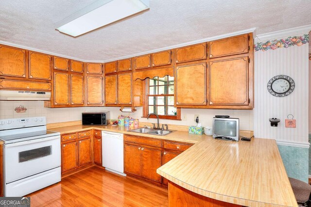 3740 Laurel Brook Way, Snellville, GA 30039 - kitchen featuring white appliances, a sink, under cabinet range hood, brown cabinets, and a textured ceiling