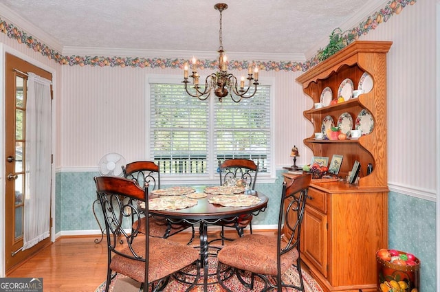 3740 Laurel Brook Way, Snellville, GA 30039 - dining room featuring wallpapered walls, a chandelier, light wood-style flooring, crown molding, and a textured ceiling
