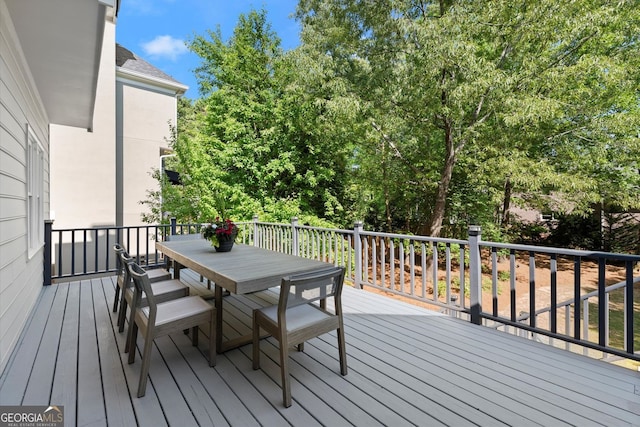 deck with outdoor dining area