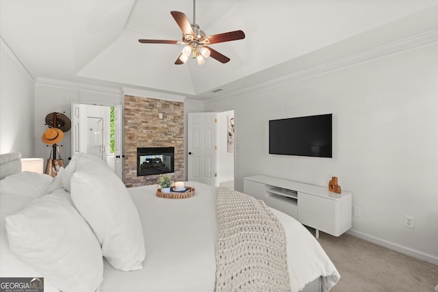 bedroom with light carpet, crown molding, a tray ceiling, a fireplace, and baseboards