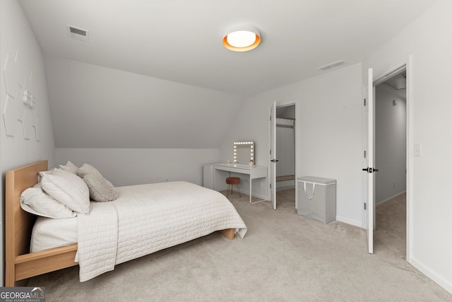 carpeted bedroom featuring vaulted ceiling and baseboards
