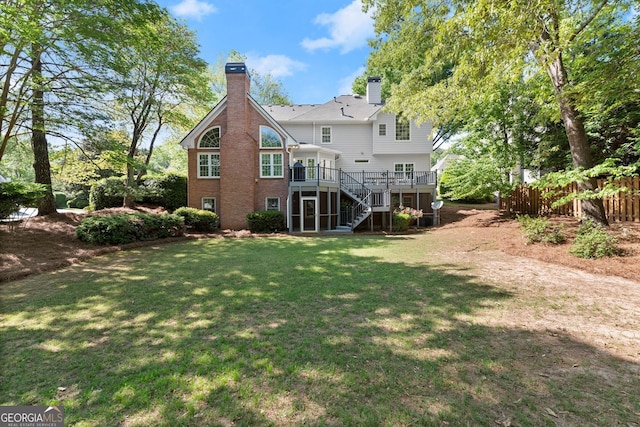 rear view of property featuring stairs, a wooden deck, and a chimney