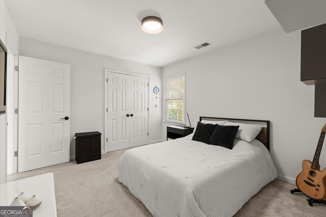 bedroom featuring light carpet, a closet, and baseboards