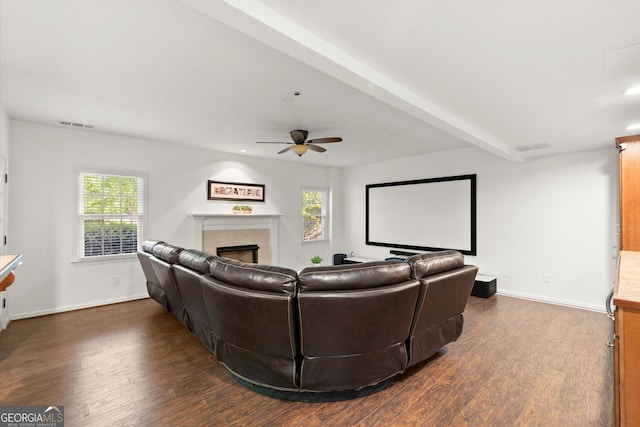 cinema room with dark wood-style flooring, a tile fireplace, baseboards, and recessed lighting