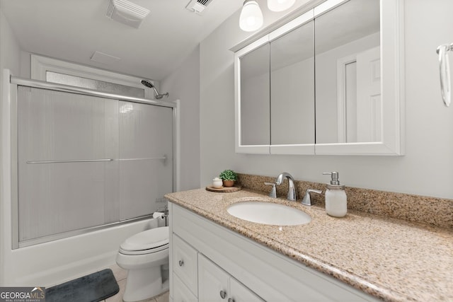 full bath featuring vanity, toilet, and combined bath / shower with glass door