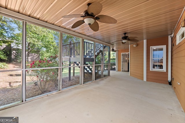 unfurnished sunroom with ceiling fan