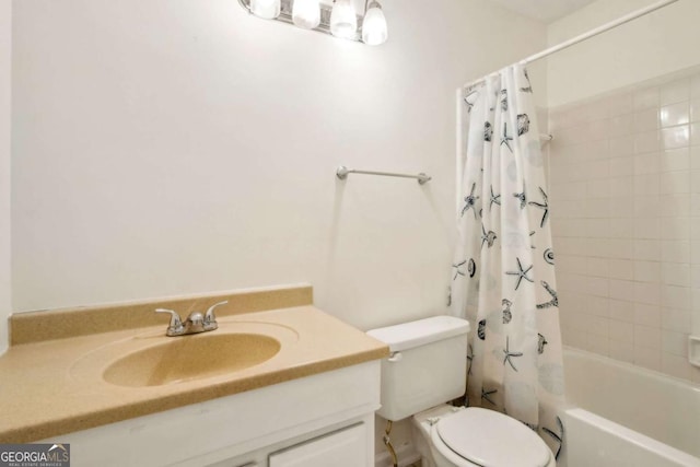 bathroom with shower / bath combo with shower curtain, vanity, and toilet