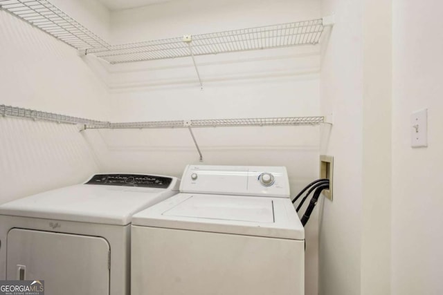 washroom featuring washer and clothes dryer and laundry area