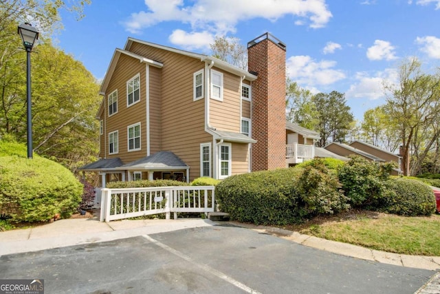view of property exterior featuring a chimney
