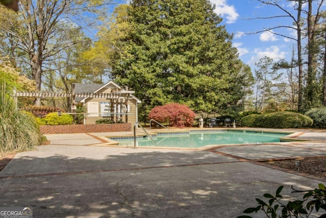 outdoor pool featuring a patio area and a pergola