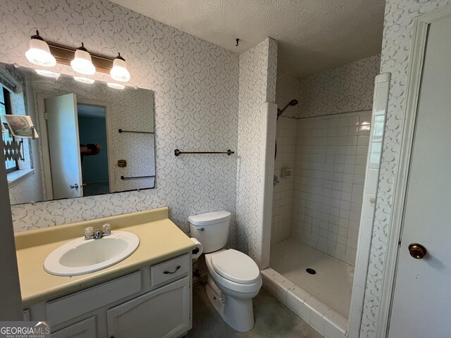 120 Treeside Dr NW, Rome, GA 30165 - full bathroom featuring wallpapered walls, toilet, vanity, a textured ceiling, and tiled shower