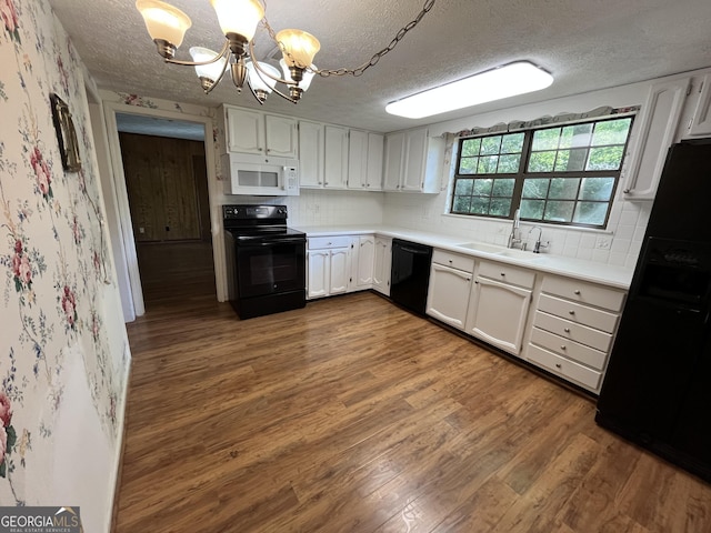 120 Treeside Dr NW, Rome, GA 30165 - kitchen with wallpapered walls, an inviting chandelier, a sink, black appliances, and a textured ceiling