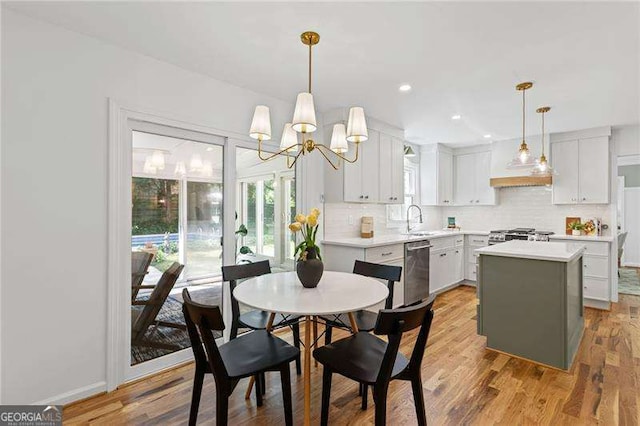 dining area with recessed lighting, a notable chandelier, and light wood-type flooring
