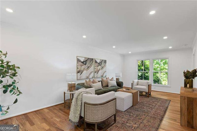 living area with recessed lighting and wood finished floors