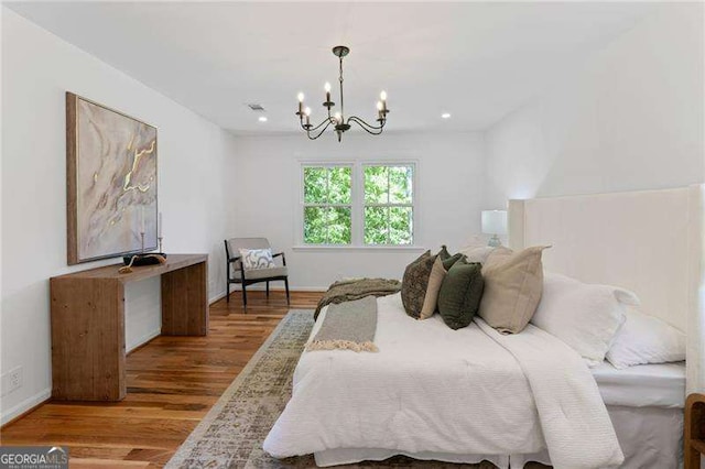 bedroom featuring recessed lighting, wood finished floors, and a chandelier