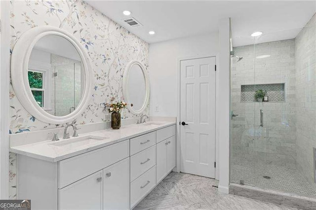 full bath featuring a stall shower, marble finish floor, a sink, and recessed lighting