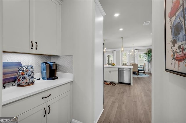5003 Fairview Cir, Villa Rica, GA 30180 - bar featuring light wood-type flooring, dishwasher, backsplash, baseboards, and recessed lighting