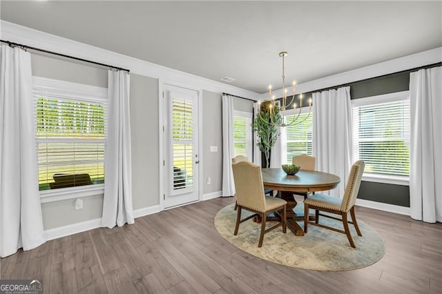 5003 Fairview Cir, Villa Rica, GA 30180 - dining room with baseboards, a notable chandelier, and wood finished floors