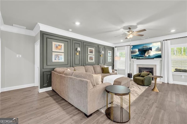 5003 Fairview Cir, Villa Rica, GA 30180 - living room featuring baseboards, crown molding, a ceiling fan, and a lit fireplace