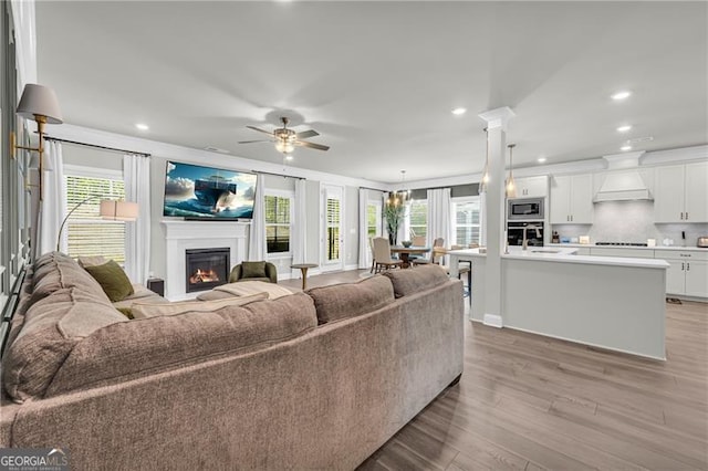 5003 Fairview Cir, Villa Rica, GA 30180 - living room with recessed lighting, a wealth of natural light, a glass covered fireplace, and light wood-type flooring