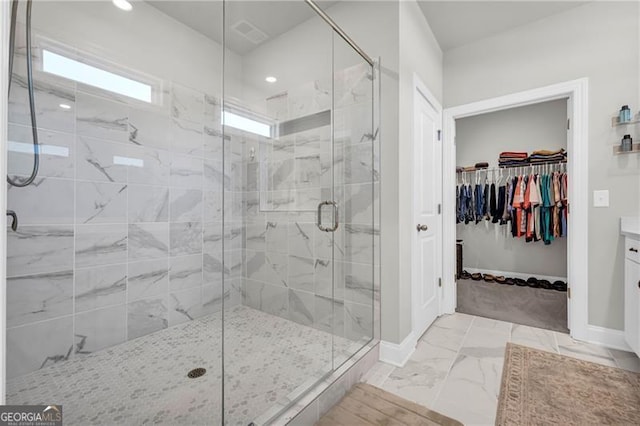 5003 Fairview Cir, Villa Rica, GA 30180 - bathroom with visible vents, baseboards, marble finish floor, a shower stall, and a walk in closet