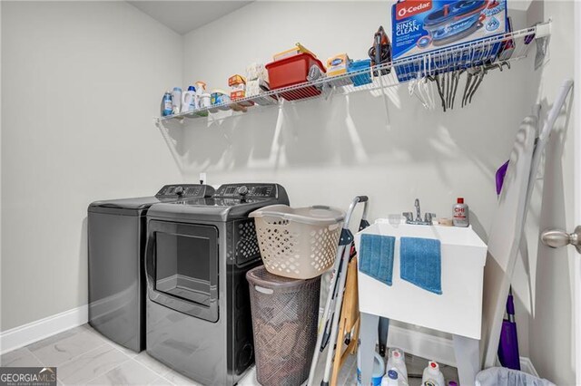 5003 Fairview Cir, Villa Rica, GA 30180 - laundry room with marble finish floor, laundry area, a sink, baseboards, and separate washer and dryer