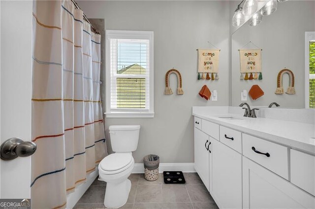5003 Fairview Cir, Villa Rica, GA 30180 - full bathroom with a wealth of natural light, tile patterned flooring, baseboards, and toilet