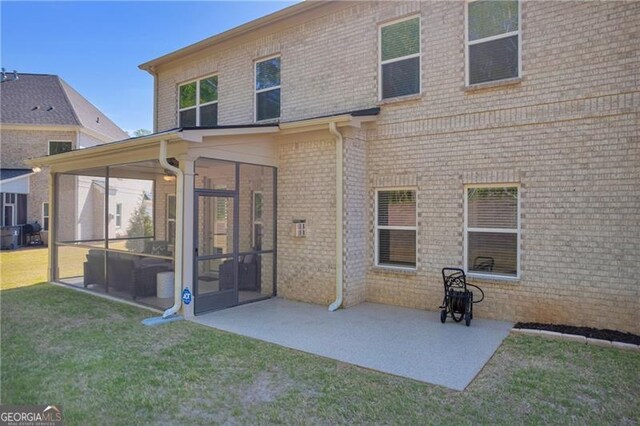 5003 Fairview Cir, Villa Rica, GA 30180 - rear view of property featuring a patio, a sunroom, brick siding, and a yard