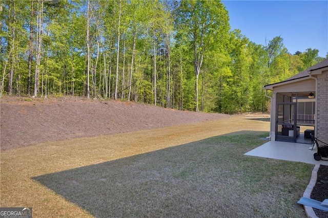 5003 Fairview Cir, Villa Rica, GA 30180 - view of yard with a sunroom, a wooded view, and a patio