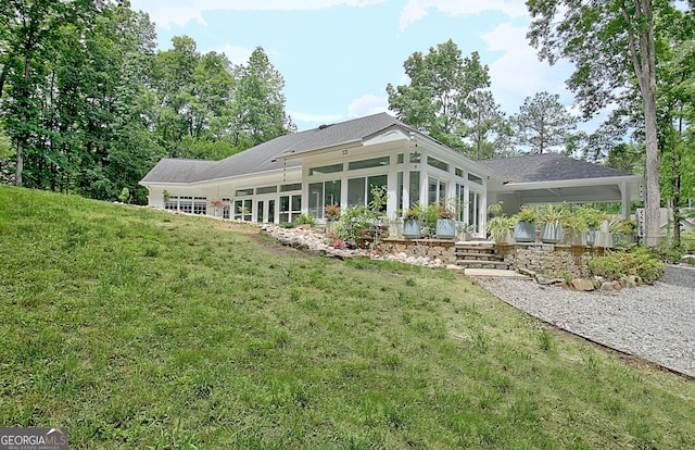 135 Adams Park Dr, Fayetteville, GA 30214 - back of house with a sunroom, a lawn, and a shingled roof