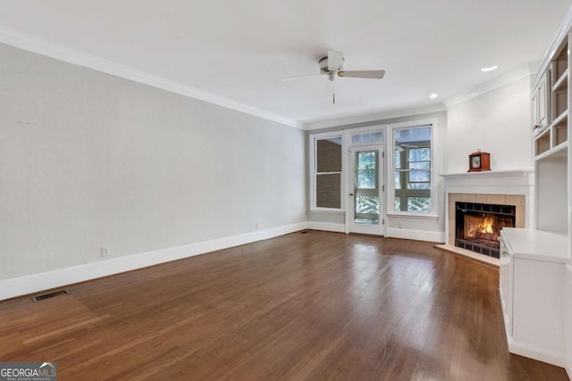 1020 Riverside Rd, Roswell, GA 30076 - unfurnished living room featuring visible vents, ceiling fan, ornamental molding, a fireplace, and dark wood-type flooring