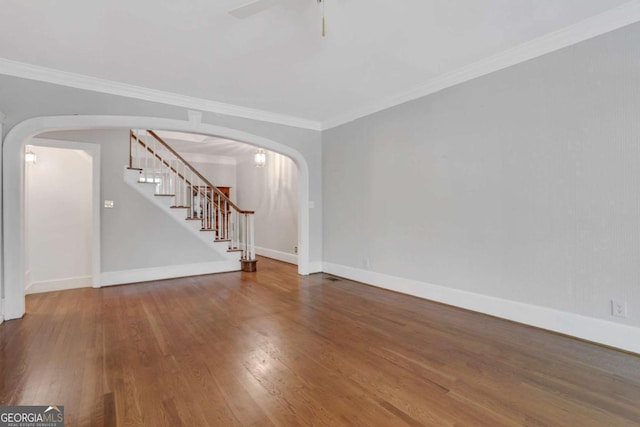 1020 Riverside Rd, Roswell, GA 30076 - unfurnished room featuring wood finished floors, a ceiling fan, stairs, and arched walkways