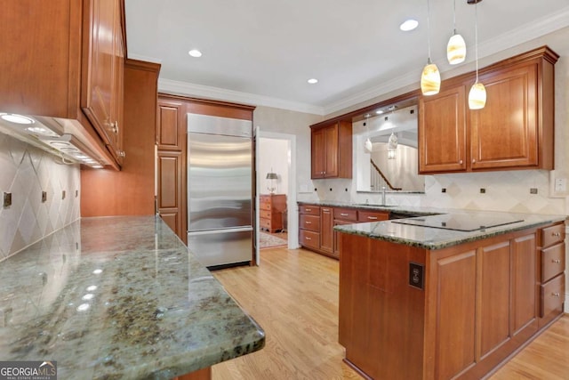 1020 Riverside Rd, Roswell, GA 30076 - kitchen featuring brown cabinets, built in fridge, black electric cooktop, ornamental molding, and stone counters