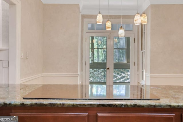 1020 Riverside Rd, Roswell, GA 30076 - kitchen with black electric cooktop, ornamental molding, decorative light fixtures, and stone countertops