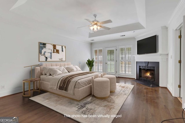 1020 Riverside Rd, Roswell, GA 30076 - bedroom with a fireplace with flush hearth, crown molding, a raised ceiling, baseboards, and dark wood finished floors