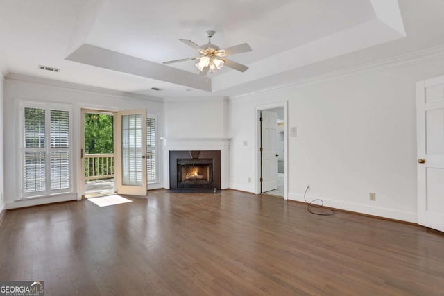 1020 Riverside Rd, Roswell, GA 30076 - unfurnished living room with a fireplace, ceiling fan, a tray ceiling, visible vents, and wood finished floors