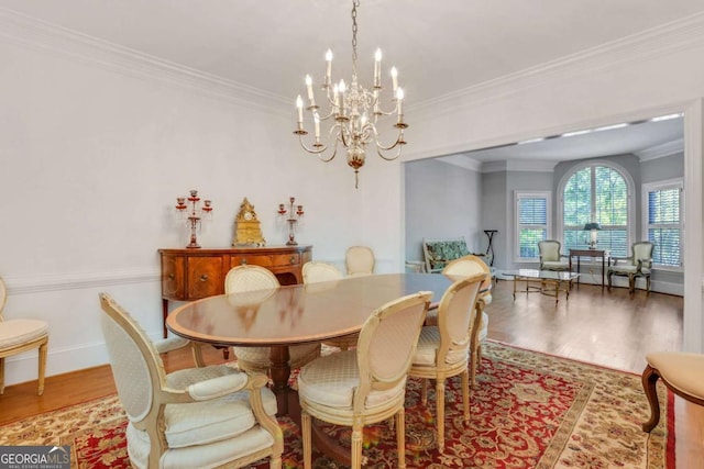 1020 Riverside Rd, Roswell, GA 30076 - dining area with ornamental molding, a notable chandelier, wood finished floors, and baseboards
