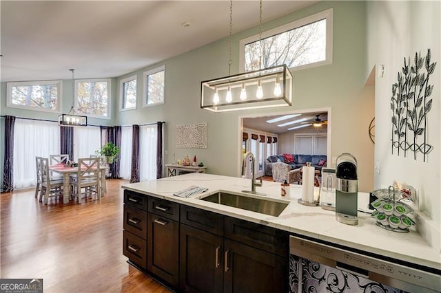 70 Denny Ridge Rd, Jasper, GA 30143 - kitchen featuring a high ceiling, light stone counters, stainless steel dishwasher, a sink, and hanging light fixtures