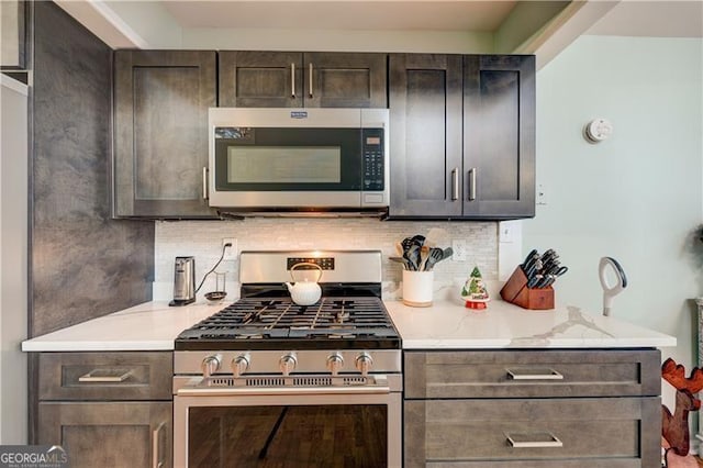 70 Denny Ridge Rd, Jasper, GA 30143 - kitchen featuring dark brown cabinets, tasteful backsplash, appliances with stainless steel finishes, and light stone counters