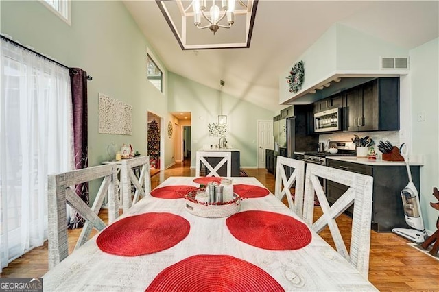 70 Denny Ridge Rd, Jasper, GA 30143 - dining space featuring light wood finished floors, visible vents, an inviting chandelier, and high vaulted ceiling