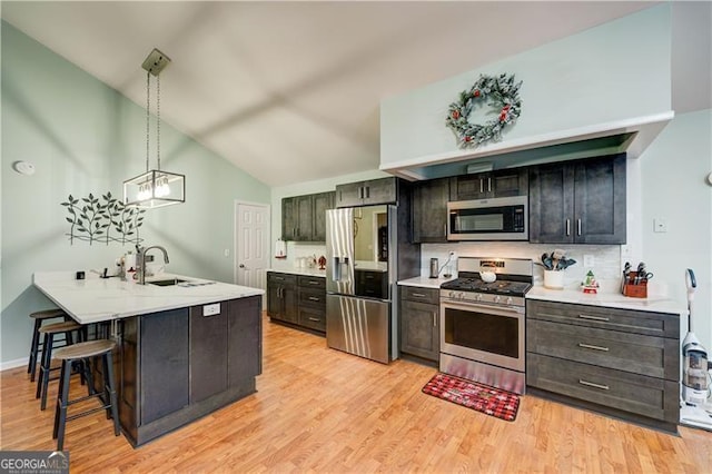 70 Denny Ridge Rd, Jasper, GA 30143 - kitchen with a sink, vaulted ceiling, decorative backsplash, light countertops, and appliances with stainless steel finishes
