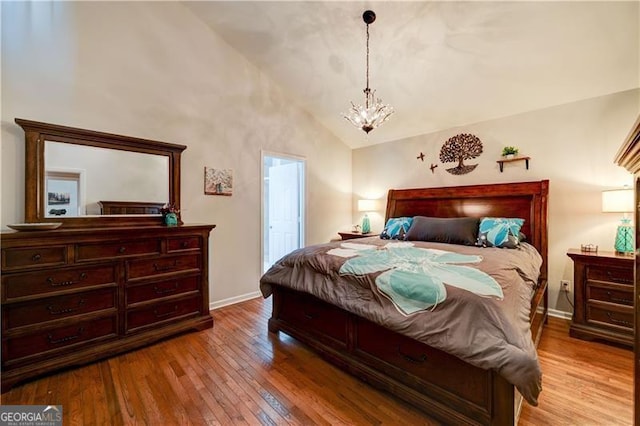 70 Denny Ridge Rd, Jasper, GA 30143 - bedroom with a chandelier, high vaulted ceiling, light wood-type flooring, and baseboards
