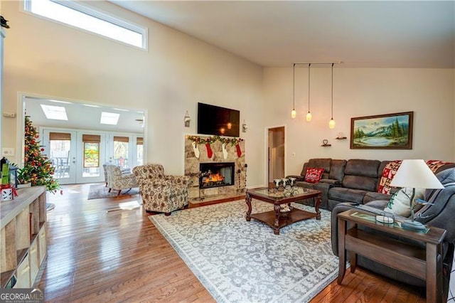 70 Denny Ridge Rd, Jasper, GA 30143 - living area with hardwood / wood-style flooring, a towering ceiling, a high end fireplace, and a healthy amount of sunlight