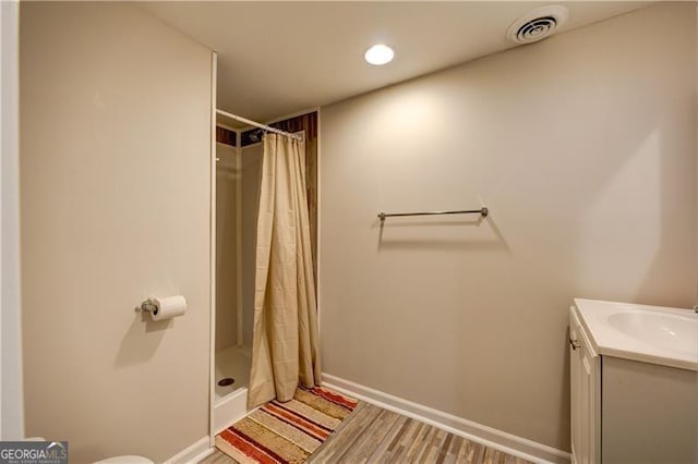 70 Denny Ridge Rd, Jasper, GA 30143 - full bath featuring wood finished floors, visible vents, vanity, baseboards, and a stall shower